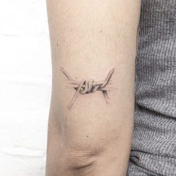 Hand poked barbed wire detail tattoo