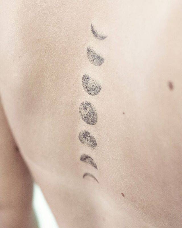 Hand poked moon phase tattoos on the back