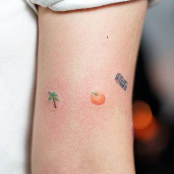 Handpoked palmtree orange and photo camera tattoo