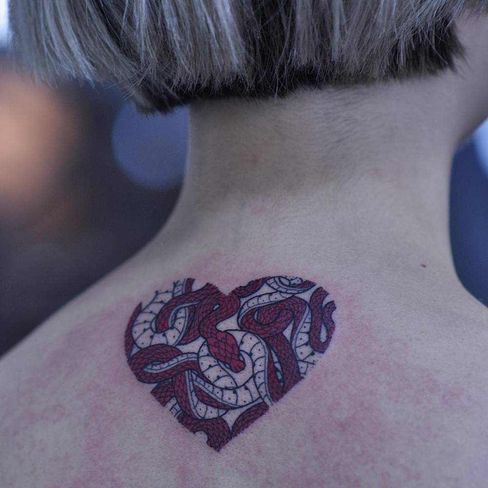 Heart shaped snakes tattoo