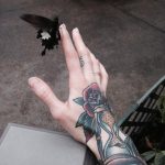 Hourglass and rose tattoo on the hand