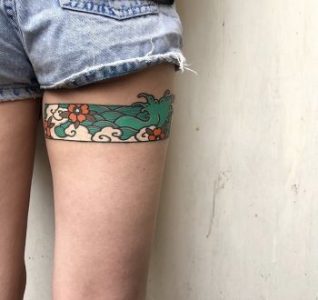 Japanese wave tattoo on the thigh