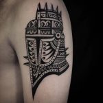 Knight helmet tattoo on the arm