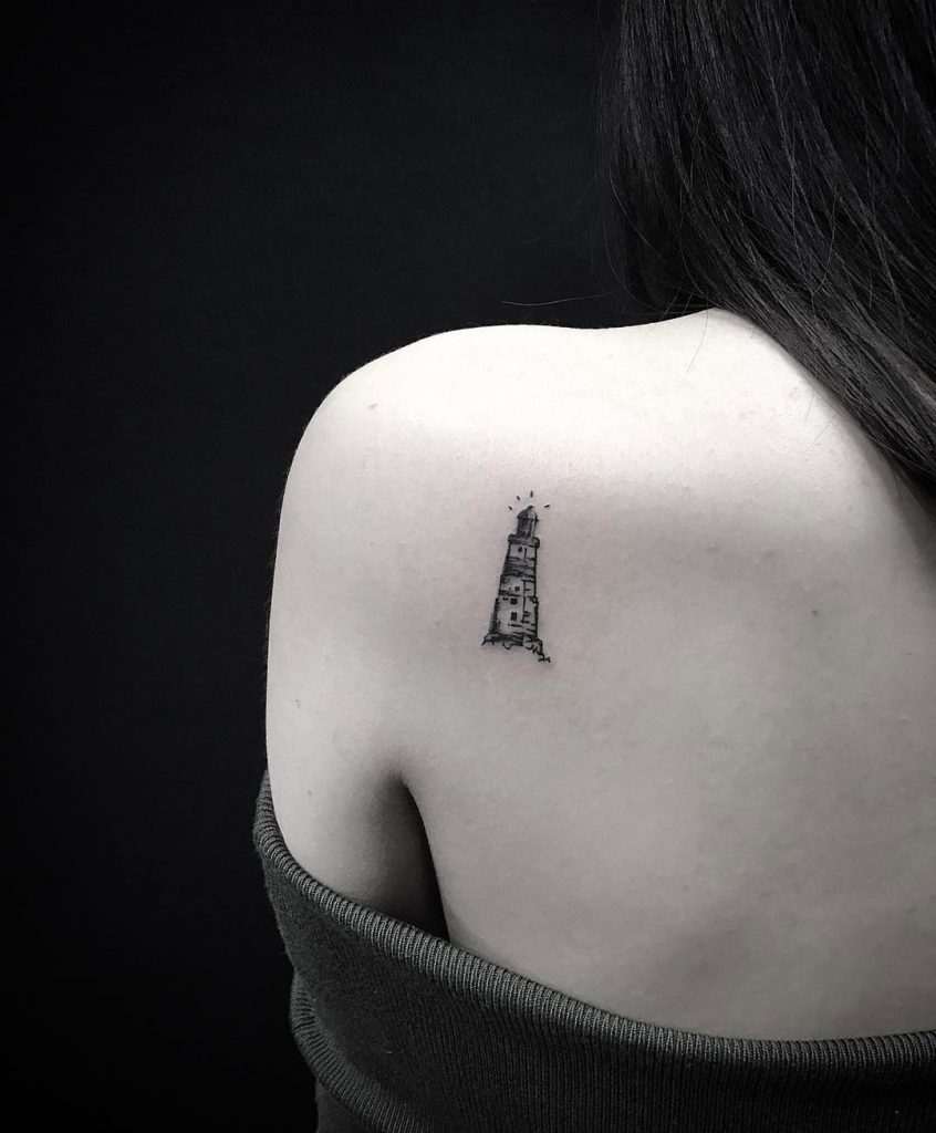 Lighthouse tattoo on the shoulder blade