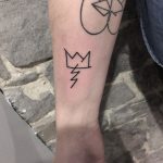 Linear bolt and crown tattoos