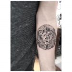 Lion head tattoo on the arm
