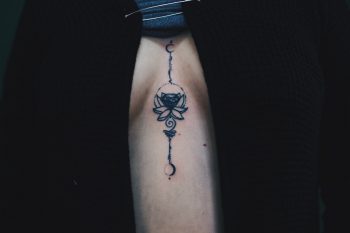 Lotus flower tattoo on the sternum