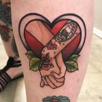 Lover's hands and heart tattoo
