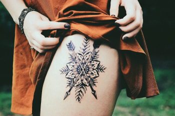 Mandala and crossed arrows tattoo