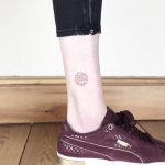 Minimalist circular maze tattoo