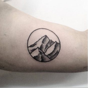 Minimalist mountain in a circle tattoo