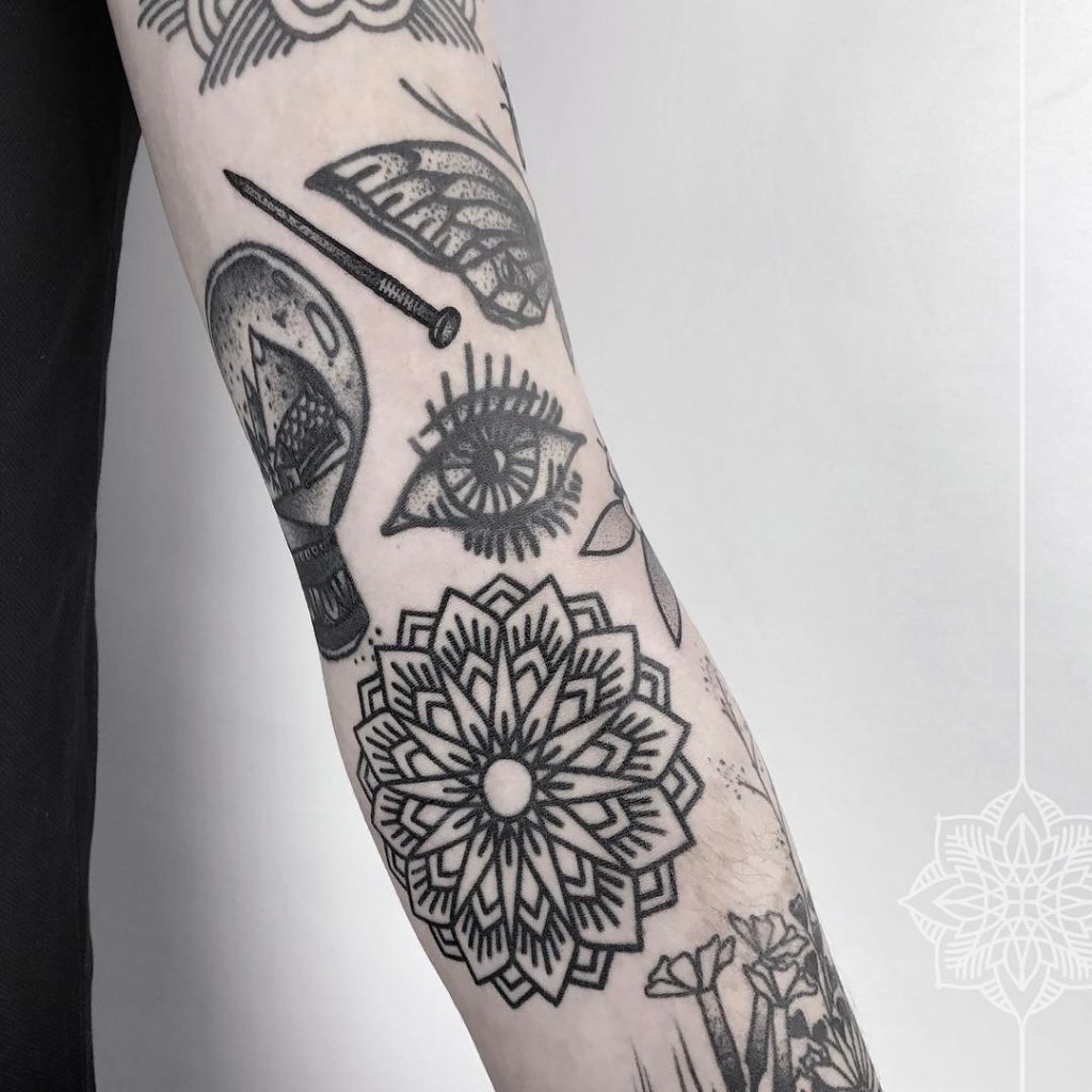 Nail, eye and mandala tattoos