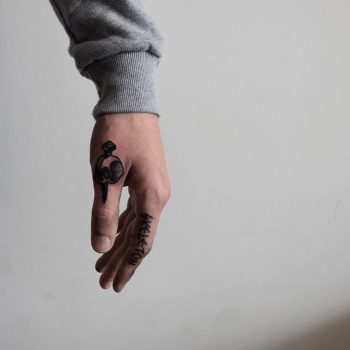Nail stabbed skull tattoo