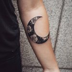 Negative space crescent moon and roses tattoo
