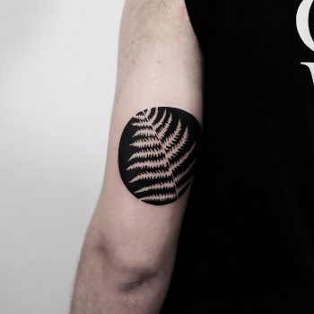 Negative space fern leaf tattoo