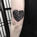 Negative space heart and flowers tattoo