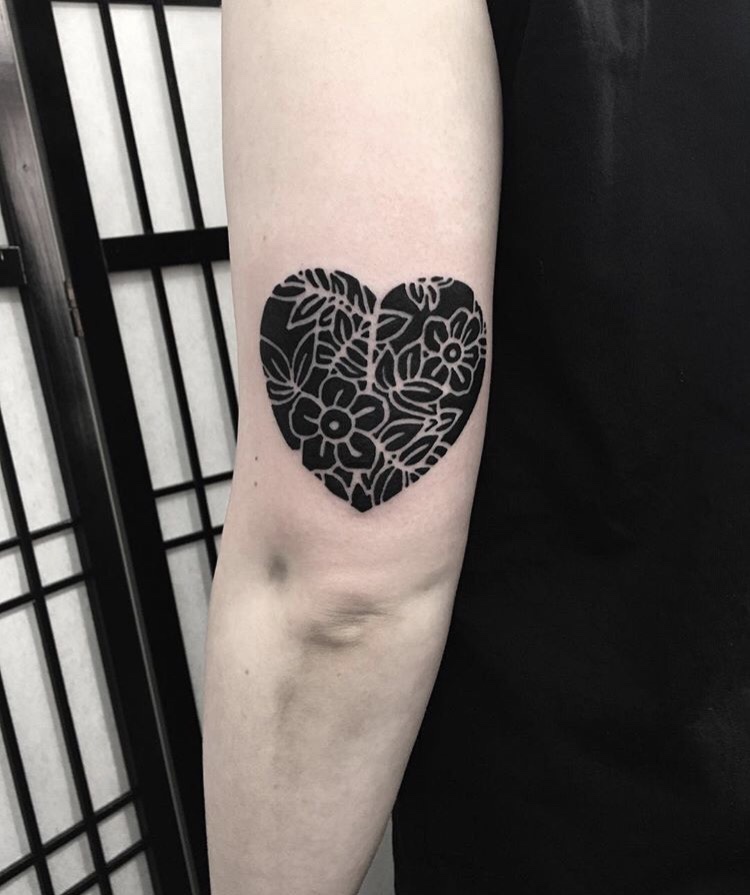 Negative space heart and flowers tattoo