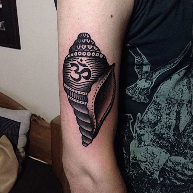 Om and shell tattoo