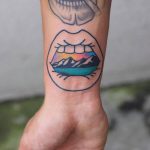 Open mouth landscape tattoo on the inner wrist