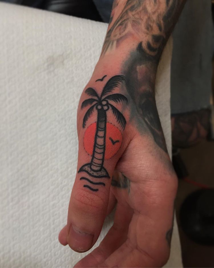 Palm tree tattoo on the thumb