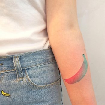 Red and teal banana tattoo