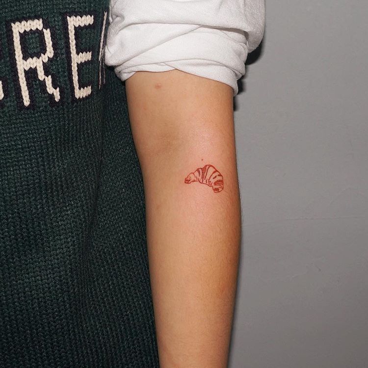 Red croissant tattoo