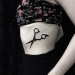 Scissors tattoo on the rib