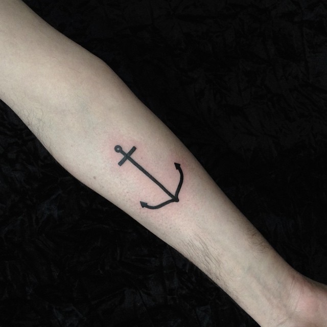 Simple black anchor tattoo on the forearm