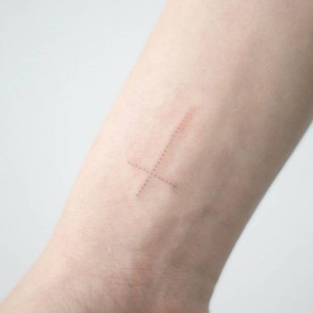 Small dotwork cross tattoo