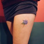 Small hydrangea tattoo on the left thigh