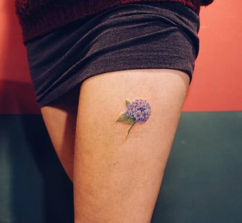 Small hydrangea tattoo on the left thigh