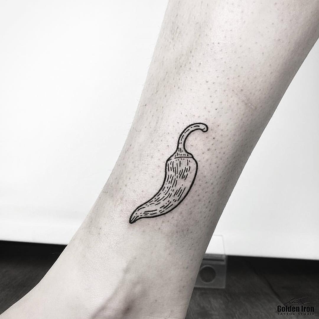 Small chilli pepper tattoo on the ankle