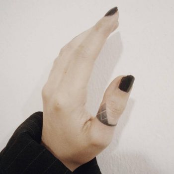 Small dotwork ornament tattoo on the finger