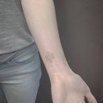 Small endless knot tattoo on the wrist