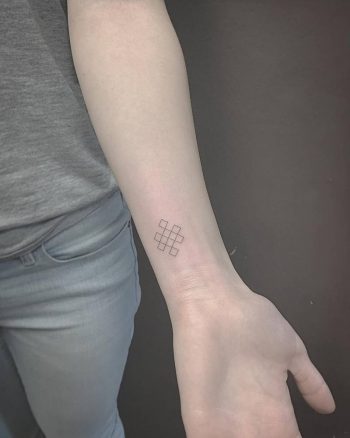 Small endless knot tattoo on the wrist