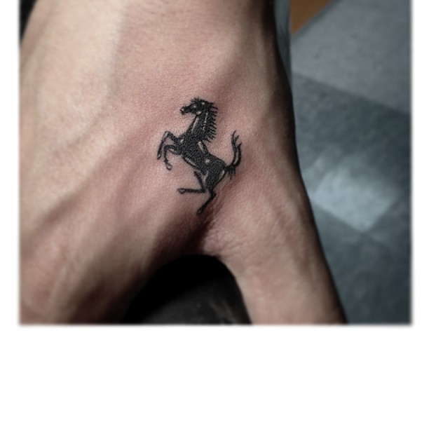 Fine line horse tattoo on the left inner forearm.