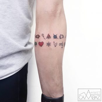 Small symbol tattoos on the forearm