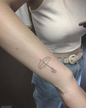Small umbrella tattoo on the wrist
