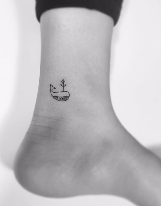 Small whale tattoo on the inner ankle