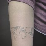 Small world map tattoo on the forearm