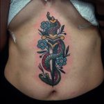 Snake and dagger belly tattoo