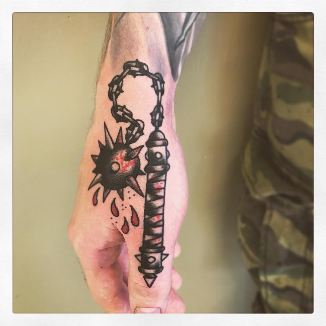 Spiked flail tattoo on the hand