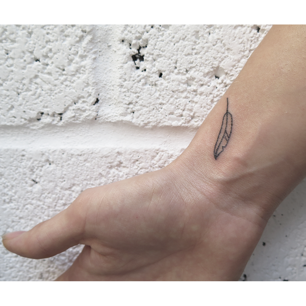 Stick and poke feather tattoo