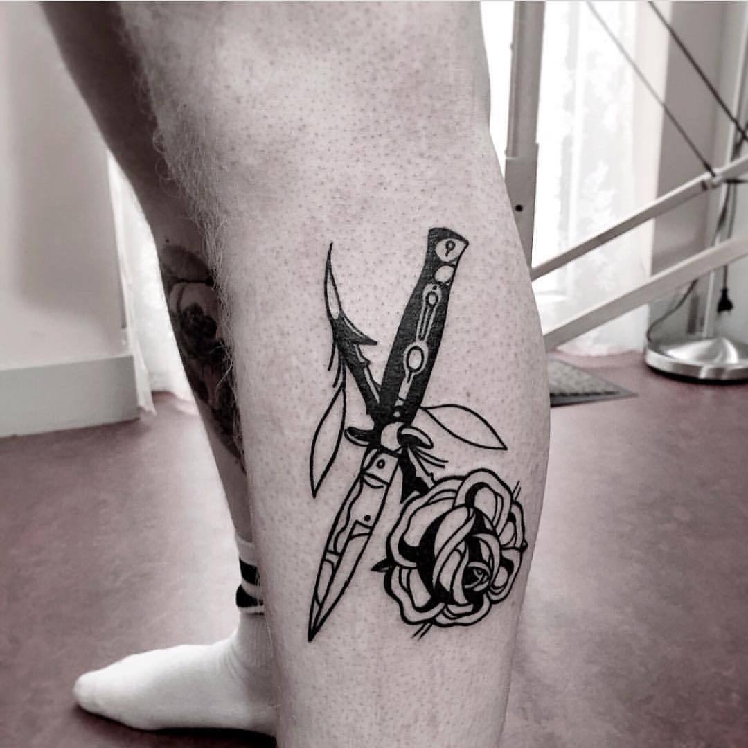 Switchblade and rose tattoo on the calf 