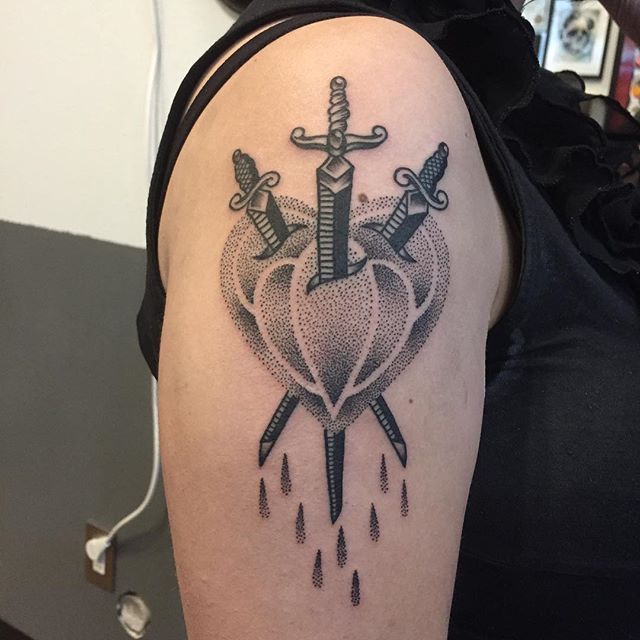 Three sword stabbed heart tattoo