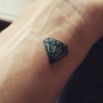 Tiny blue diamond tattoo on the wrist