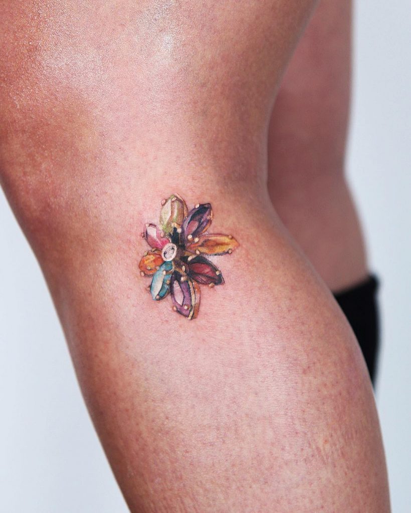 Tiny gem flower tattoo