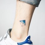 Tiny kite tattoo on the ankle