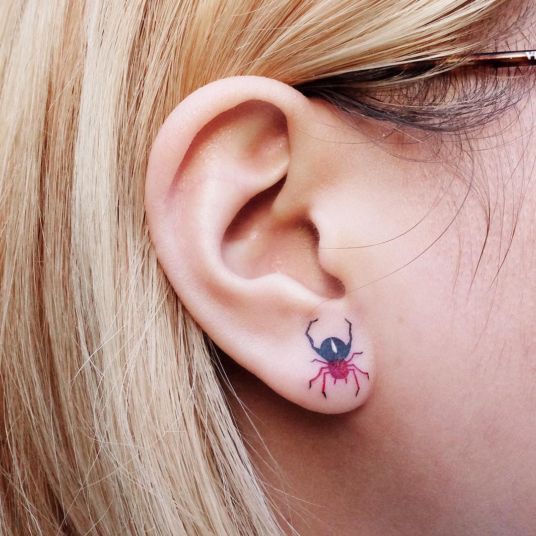 Tiny spider tattoo on the ear