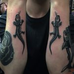 Two black lizard tattoos